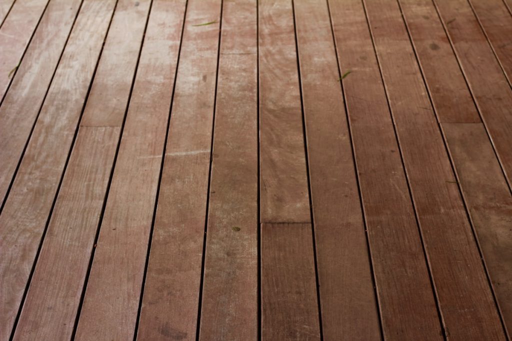 Bare hardwood floorboards ready for refinishing