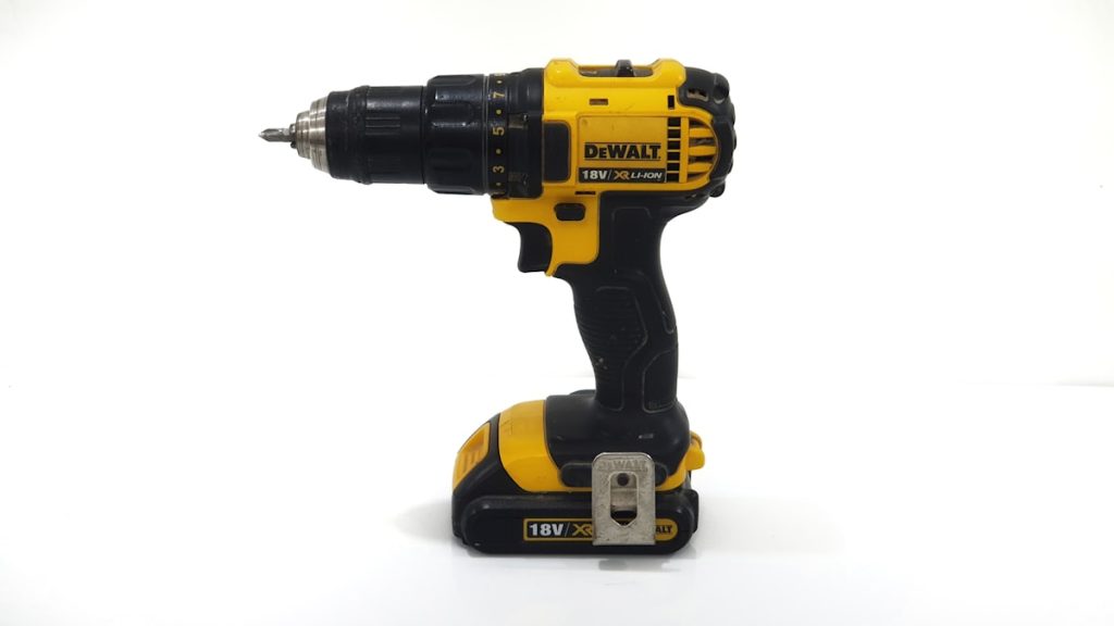 Yellow and black cordless drill resting on a work surface