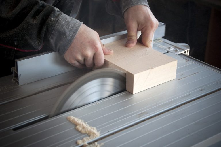 Power saw blade cutting through material in a workshop
