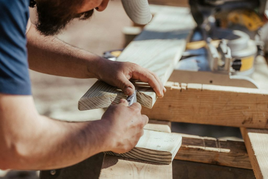 Woodworker shaping a piece of timber on a workbench
