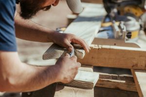 Woodworker shaping a piece of timber on a workbench