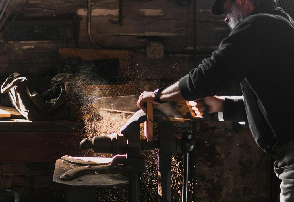 Woodworker cutting timber in a home workshop